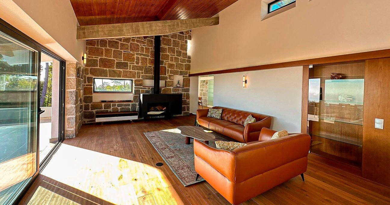 Comfortable lounge with a fireplace and seating area in the Panorama Residence