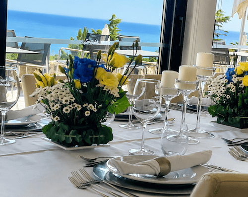 Wedding table with candles and bright flowers at Quinta Vale da Roca