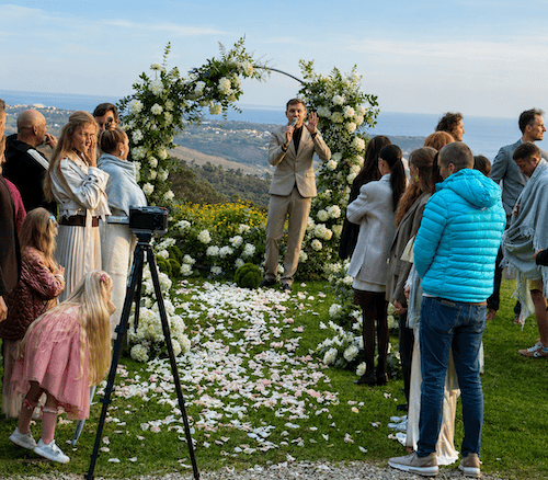 Guests standing near the decorated wedding reception