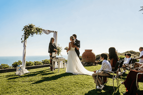 Bride and groom exchanging vows overlooking the Atlantic Ocean at Quinta Vale da Roca