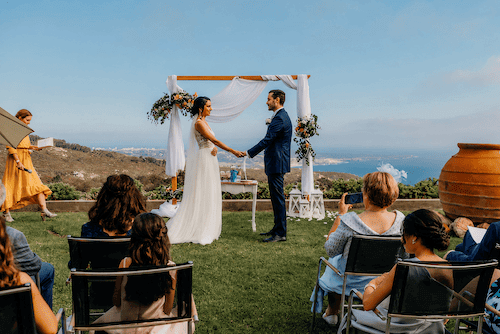 Bride and groom standing at the reception overlooking the Atlantic Ocean at Quinta Vale da Roca