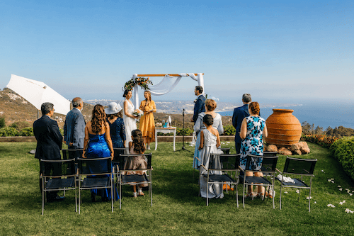 Guests applauding the bride and groom with panoramic ocean views near Sintra