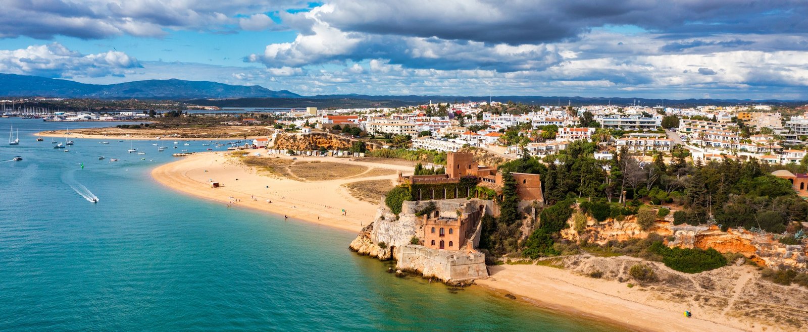 Panoramic view of Praia Grande with its long sandy beach, Atlantic waves and coastal cliffs near Sintra